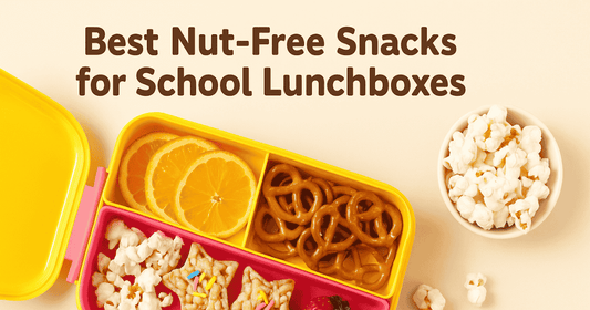 Bright pink and yellow lunchbox filled with nut-free snacks including Lumi Bites star-shaped treats, pretzels, fruit slices, popcorn, and a strawberry on a cream background.